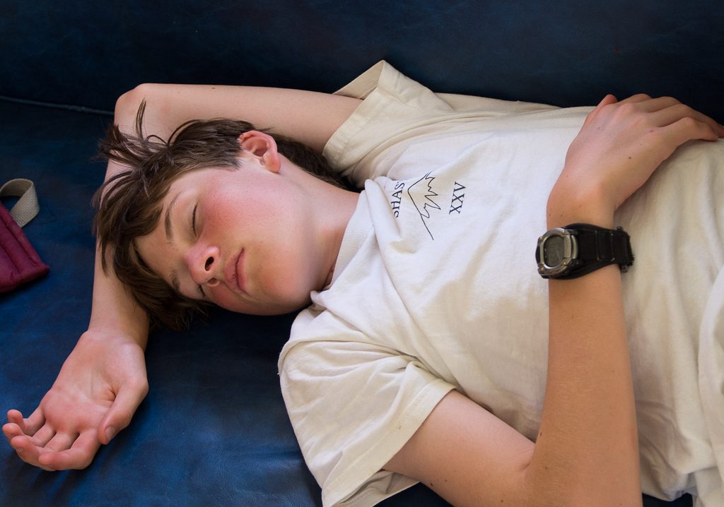 Photograph of a teenage boy sleeping