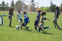 photograph of children playing soccer