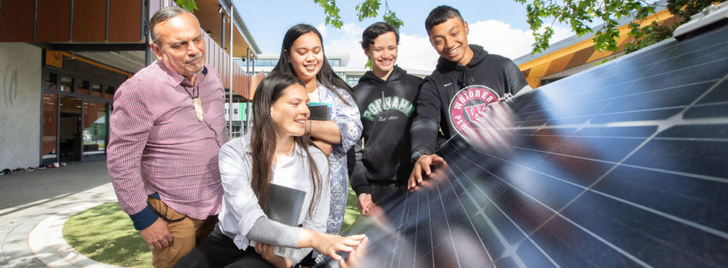 Photograph of school community with solar panels